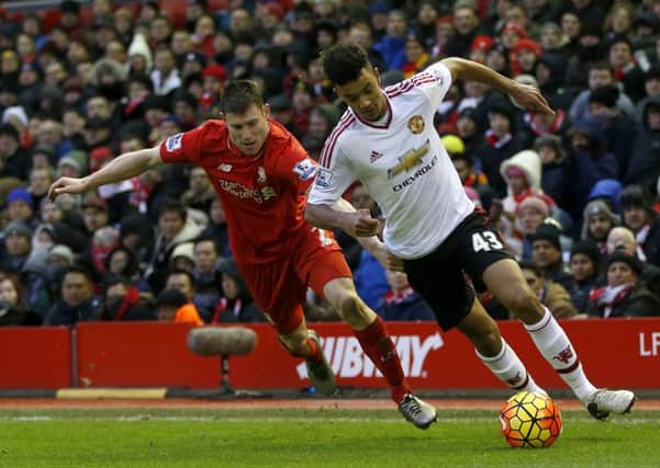 Liverpool's James Milner (left) and Manchester United's Cameron Borthwick-Jackson battle for the ball