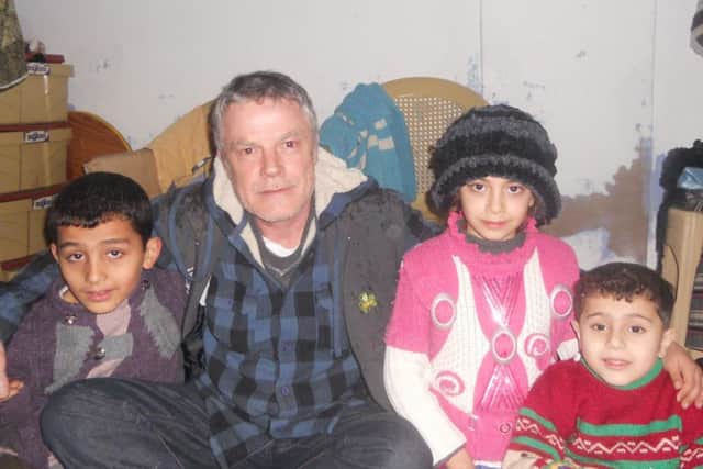 Davy Adams with children in Syria. The child on the right suffers from a serious blood disorder, but after fleeing fighting in their home city his parents can neither afford nor access the medicine vital to his survival