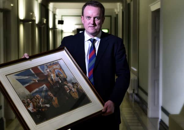 Colin McCusker pictured in Parliament Buildings, Stormont, with a portrait of his father Harold McCusker