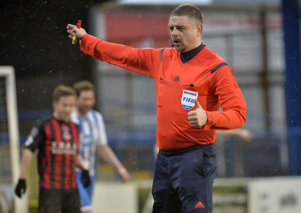 Referee Raymond Crangle was the centre of attention on Saturday