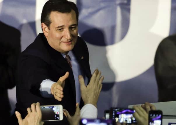 Republican presidential candidate, Senator Ted Cruz, arrives for a caucus night rally, in Des Moines, Iowa on Monday. Cruz sealed a victory in the Republican caucuses there. (AP Photo/Chris Carlson)