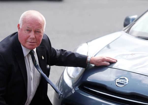 Sammy Brush pictured beside his car which was vandalised outside his house in Ballygawley, Co Tyrone