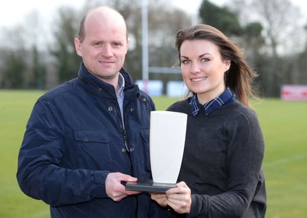 Warrenpoint boss Barry Gray receives his award from Laure James of the NIFWA
