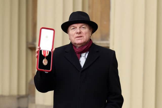 Singer, songwriter and musician Sir Van Morrison at Buckingham Palace, London, after being knighted by the Prince of Wales