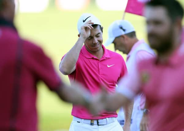 Rory McIlroy removes his cap at the end of his second round at the Omega Dubai Desert Classic