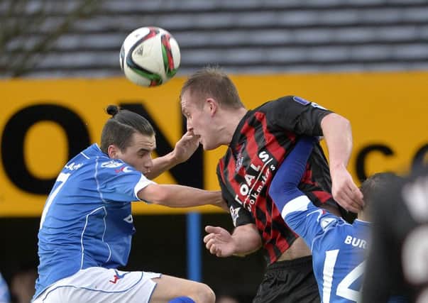 .
Dungannon's Jamie Glackin  in action with Crusaders  Jordan Owens