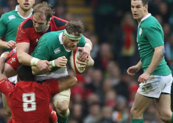 Ireland's Jamie Heaslip is tackled by Wales' Alun Wyn Jones