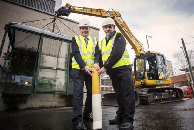 Chief medical officer Dr Michael McBride and Public Health Agency chief executive Dr Eddie Rooney on site as a smoking shelter at the Northern Ireland Cancer Centre is removed