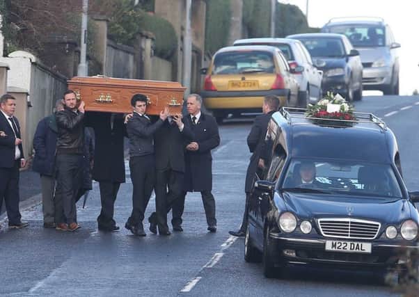 Family carry the coffin of 48-year-old Anthony McErlain