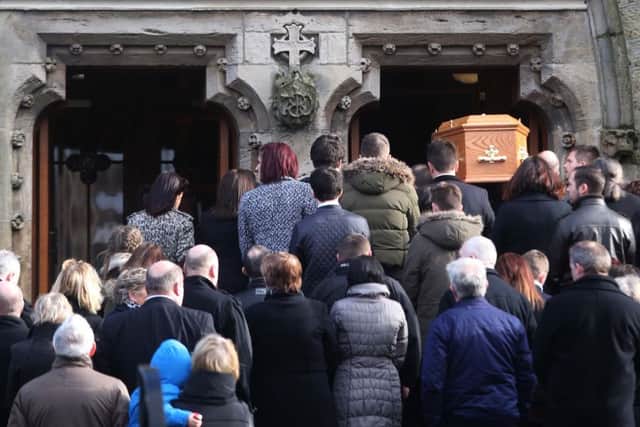 The funeral procession entering the church
