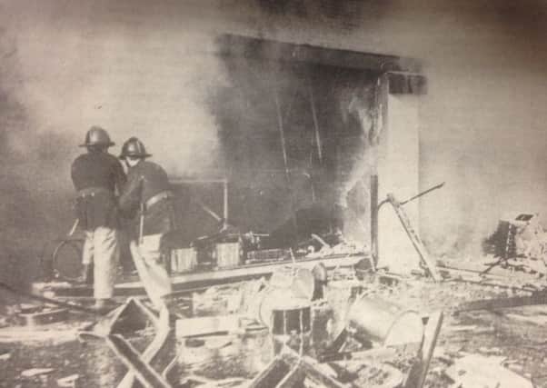 Firefighters at the scene of the bomb blast in February 1976