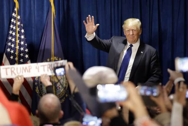 Republican presidential candidate, businessman Donald Trump takes the stage to speak to supporters during a primary night rally, Tuesday, Feb. 9, 2016, in Manchester, N.H. (AP Photo/David Goldman)