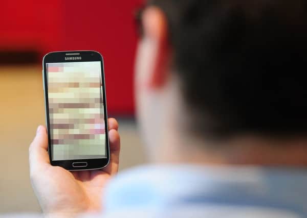 PICTURE POSED BY MODEL

Undated file photo of a man looking at a mobile phone, as revenge porn is to become a criminal offence carrying a penalty of up to two years in prison in Northern Ireland
