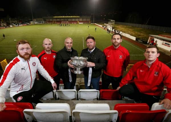 Cliftonville's Conor Devlin, Ryan Catney and manager Geard lyttle along with Ards players James Cully,
Ross Arthurs and manager Niall Currie ahead of the JBE League Cup Final