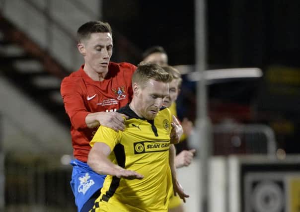 Cliftonville's Chris  Curran in action with Ards Gary Dorrian