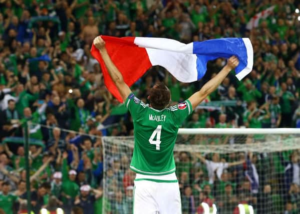 Gareth McAuley celebrates Northern Ireland qualifying for the Euro Finals for the first time in their history.