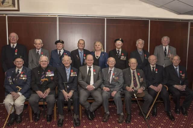 Regine McCullough, France's honorary consul in Northern Ireland, with former servicemen after the presentation of the Legion d'Honneur medals at Thiepval barracks