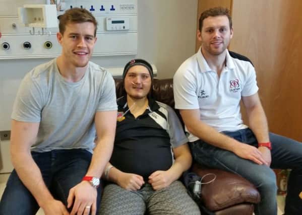 Kieran Bowes pictured with two of his Ulster rugby heroes, Andrew Trimble and Darren Cave, who visited him in hospital before Christmas.