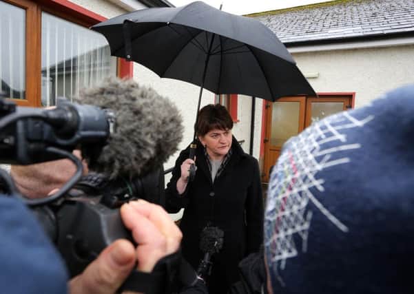 First Minister Arlene Foster surveys the damage at Strawletterdallon Orange hall, near Newtownstewart in Co Tyrone