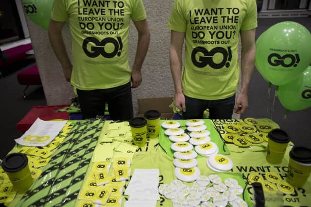 Men wear t-shirts by a merchandise stall before the start of a rally held by the Grassroots Out (GO), anti-EU campaign group, at the Queen Elizabeth II conference centre in London, held to coincide with the EU summit in Brussels, Friday, Feb. 19, 2016.  (AP Photo/Matt Dunham)