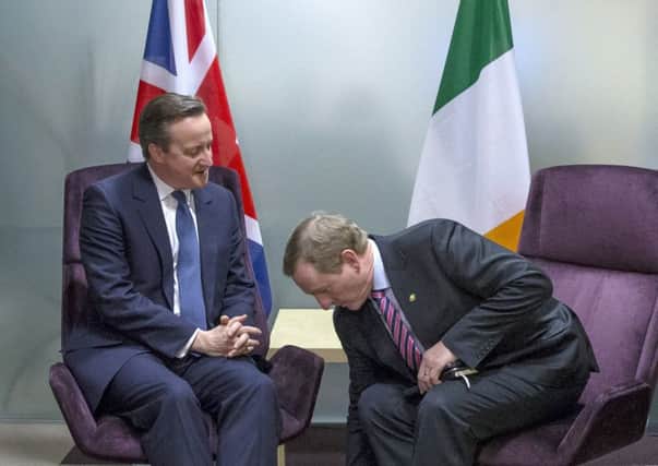 David Cameron, left, speaks with Irish PM Enda Kenny at meeting on sidelines of Brussels summit on Friday