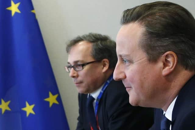 British Prime Minister David Cameron, right, listens to comments during a meeting on the sidelines of an EU summit in Brussels on Friday, Feb. 19, 2016. British Prime Minister David Cameron faces tough new talks with European partners after through-the-night meetings failed to make much progress on his demands for a less intrusive European Union.  (Francois Lenoir, Pool Photo via AP)