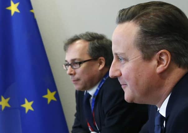 British Prime Minister David Cameron, right, listens to comments during a meeting on the sidelines of an EU summit in Brussels on Friday, February 19, 2016