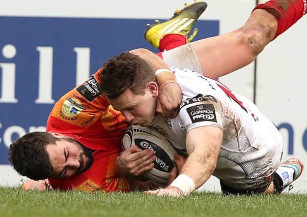 Ulster Craig Gilroy scores a try while being tackled by  Scarlets  Gareth Owen
