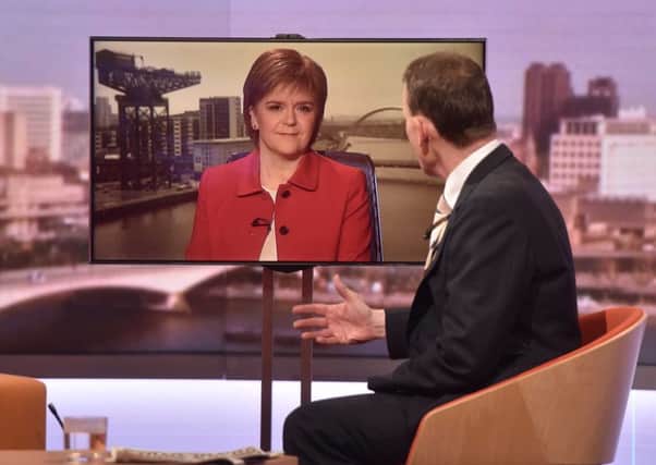 First Minister of Scotland Nicola Sturgeon (left) appearing via video link, speaking to Andrew Marr (right) while appearing on BBC1's The Andrew Marr Show. Photo: Jeff Overs/BBC/PA Wire