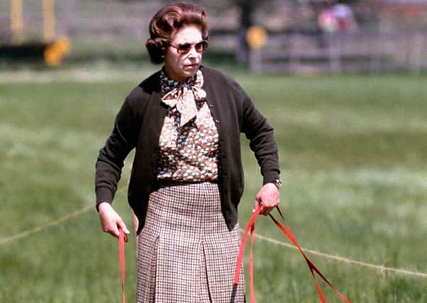 The Queen pictured with some of her dogs in May 1980