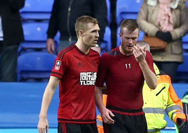 West Bromwich Albion's Chris Brunt who was struck with a coin with team mate Darren Fletcher