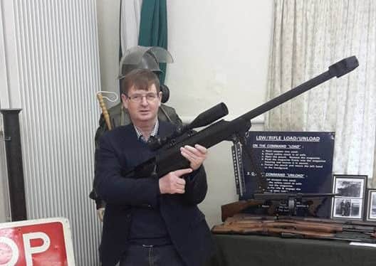Willie Frazer posing with a sniper rifle at an exhibition. From his facebook