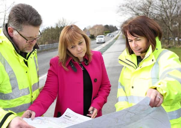 Transport Minister Michelle McIlveen looks over plans for the new road with Andrew Hitcher and Deirdre Mackle, Transport NI