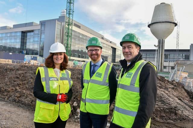 Simon Hamilton (centre) at the Ulster Hospital site with Naomi Dunbar, assistant director strategic and capital development,  and Seamus McGoran, director of hospital services