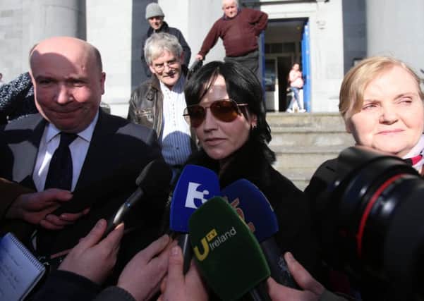 Cranberries singer Dolores O'Riordan (centre) leaves Ennis District Court flanked by her mother Eileen and solicitor Bill O'Donnell, after she avoided a criminal conviction and was fined 6,000 euro (Â£4,690) for head-butting and spitting on a police officer following an alleged air rage incident