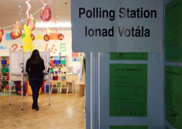 Laura Kidney casts her vote at a polling station at St. Anthony's Boys Primary School in Ballinlough, Cork, as the country heads to the polls facing one of the most unpredictable outcomes in recent times