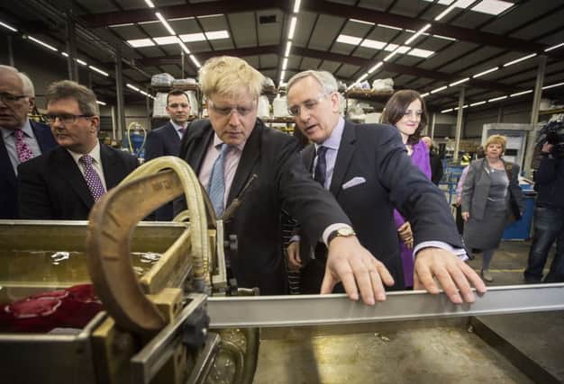 London Mayor Boris Johnson pictured with Boomer Industries managing director Andrew Robinson, flanked by Lagan Valley MP Jeffrey Donaldson and Secretary of State for Northern Ireland Theresa Villiers