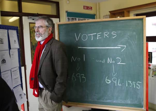 Sinn Fein party leader Gerry Adams casts his vote at polling station in Ravensdale in Co Louth on Friday. (AP Photo/Peter Morrison)