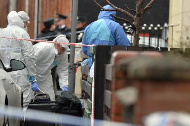 Police and forensic officers at the murder scene