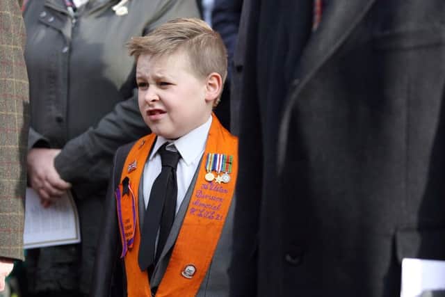 A young Orangemen pays his respects