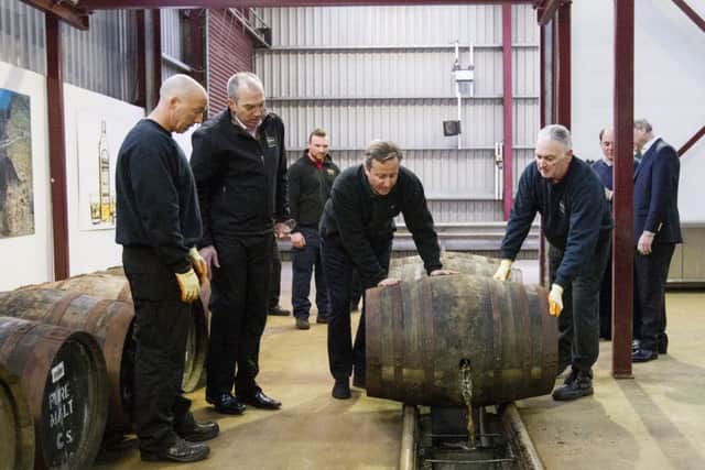 Prime Minister David Cameron (centre left) during his visit to Bushmills distillery in Co Antrim as he continues a tour of the UK setting out the case for staying in the European Union. Photo: Liam McBurney/PA Wire