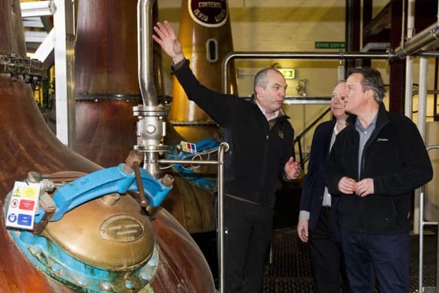 Prime Minister David Cameron shown the whiskey stills of Bushmills Distillery by manager Colum Egan (left) and Chairman David Gosnell during his visit to Bushmills distillery in Co Antrim as he continues a tour of the UK setting out the case for staying in the European Union. Photo: Liam McBurney/PA Wire