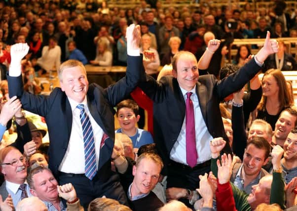 Fianna Fail Leader Micheal Martin (right) and Michael McGrath (left) celebrate at the general election 2016 count at the City Hall in Cork, Ireland.  Photo: Chris Radburn/PA Wire