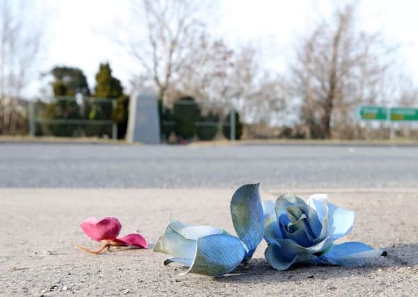 The scene on the Drum Road outside Cooktown at the Teebane memorial where flowers and wreaths were destroyed and thrown across the road in an overnight attack