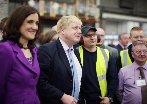 Theresa Villiers, left, with Boris Johnson and staff of Boomer Industries on a visit to the business on Monday