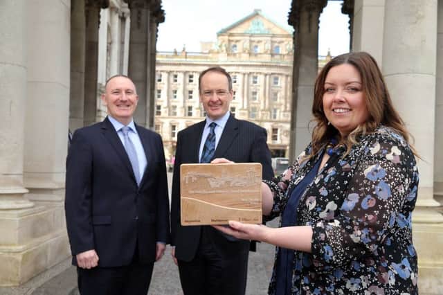 City Councillor Deirdre Hargey, Howard Hastings, centre, and Gerry Lennon celebrate Belfasts win at the Guardian and Observer Travel Awards 2016.