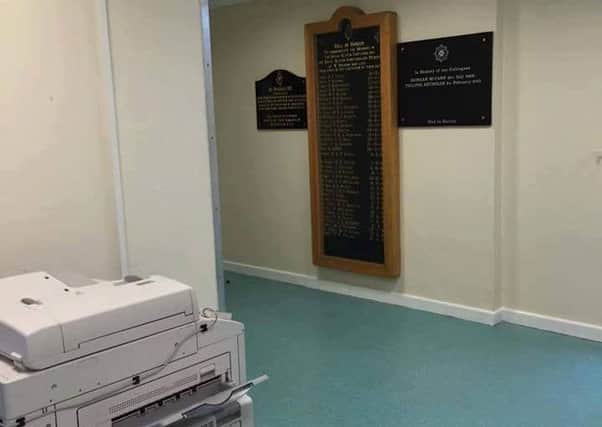The RUC memorial, in the place where it was moved beside a photocopier at Strand Road PSNI station
