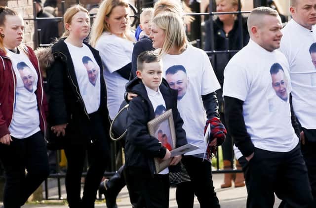 Mourners wore shirts bearing an image of Stephen Carson