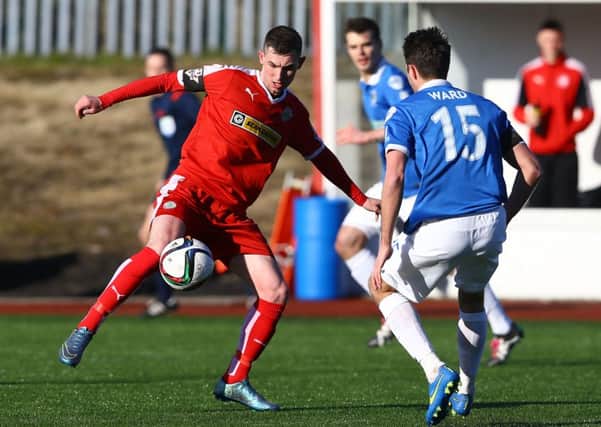 Cliftonville's Daniel Hughes with Linfield's Sean Ward