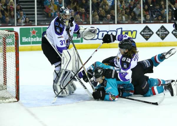 Belfast Giants' Kris Beech and Chris Higgins with Braehead Clan's Chris Holt and Marcus Gotz